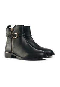 Black ankle boots made of smooth leather featuring a side zipper, a buckle strap, and a low block heel with a subtle gold accent.