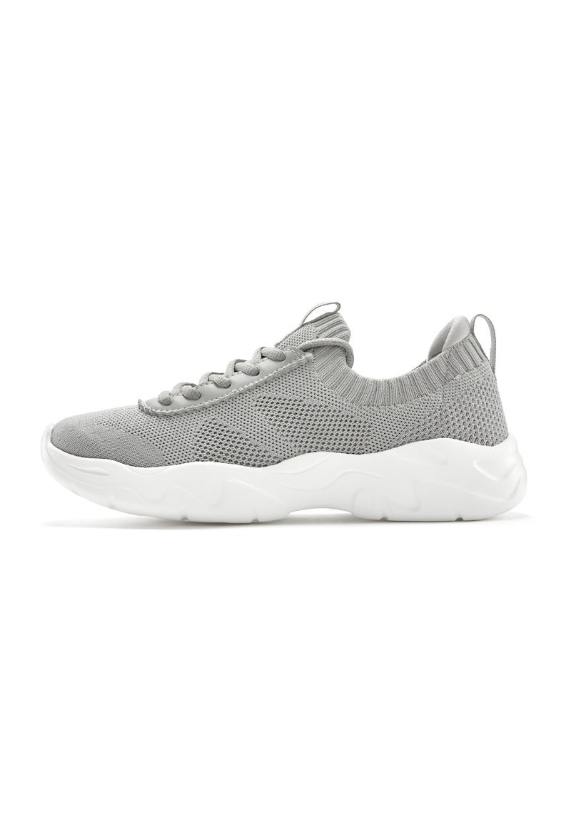 Gray knit sneaker with a textured upper, elastic collar, and white rubber sole featuring a wavy pattern. Lace-up design.