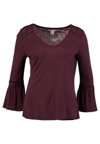 Burgundy long-sleeve top with a V-neckline, featuring lace accents on shoulders and flared cuffs, made from soft, stretchy fabric.
