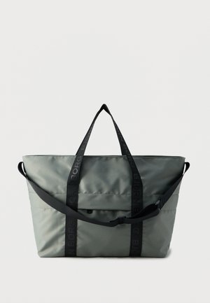 Gray large tote bag with black straps, a front pocket, and an adjustable crossbody strap, set against a plain white background.