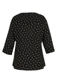 Chemise noire à manches longues avec un petit motif floral beige, présentant un col rond et une coupe décontractée, vue de dos.