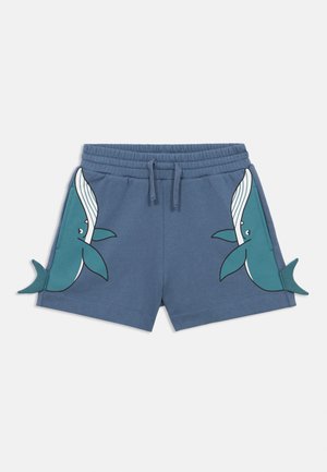 Pantaloncini di cotone blu con vita elasticizzata. Presentano illustrazioni di balene in turchese su entrambi i lati e accenti a forma di coda sull'orlo.