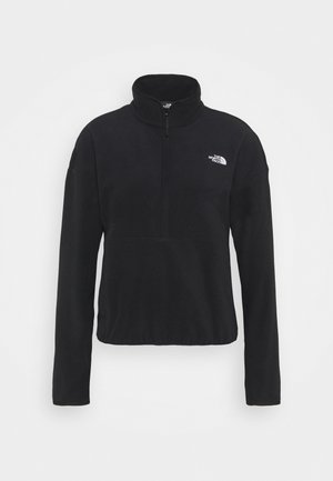 Czarna bluza polarowa z zamkiem do ćwiartki i wysokim kołnierzem, z białym logo "The North Face" na lewym piersi.