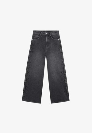 Wide-leg jeans in dark gray denim featuring decorative studded accents along the side seams. Classic five-pocket design with front button closure.