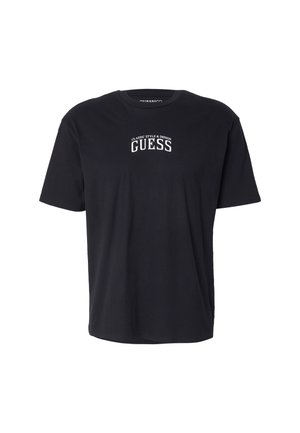 Camiseta negra de manga corta hecha de algodón, con cuello redondo y un logo impreso en blanco que dice "ESTILO Y DISEÑO CLÁSICOS" sobre "GUESS."
