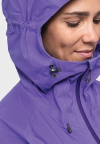 Purple outdoor jacket with a cinched hood, featuring adjustable toggles, textured fabric, and a slim fit design.