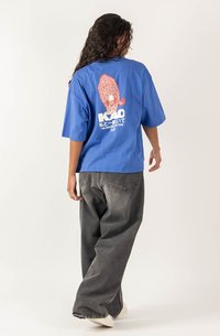 Short-sleeve blue t-shirt made of cotton, featuring a red graphic of a leopard and text on the back. Paired with loose gray pants.