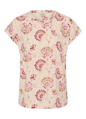 Gaiši bēša auduma tops ar ziedu rakstu; tam ir īsas piedurknes, apaļa kakla līnija un smalki raksti rozā un brūnā toņos.