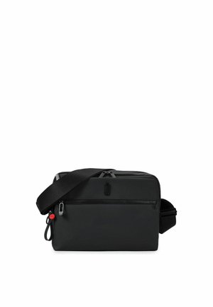 Petit sac bandoulière noir compact avec poche zippée avant, bandoulière réglable et finition mate lisse.