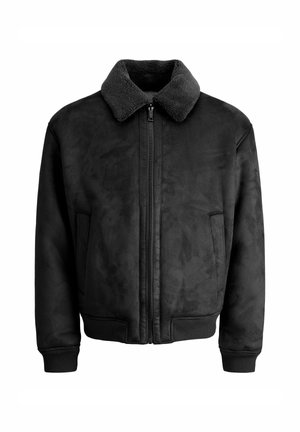 Giacca bomber nera in ecopelle scamosciata con colletto morbido e testurizzato, chiusura frontale con zip e tasche laterali. Maniche e orlo a coste.