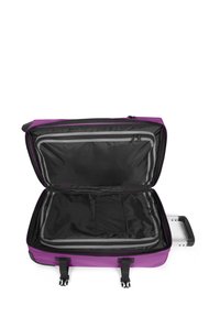 Purple suitcase with a zippered opening, black interior, mesh pocket, and contrasting grey trim. Features a retractable handle and sturdy clips.