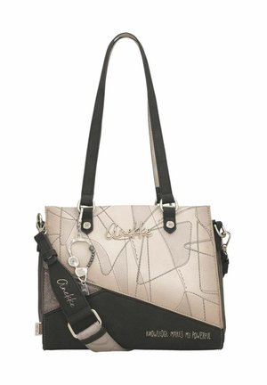 Sac à main beige et noir avec motifs abstraits en lignes, nom de la marque argenté "Anekke", bandoulière amovible et accessoire porte-bonheur, texte "La connaissance me rend puissant."