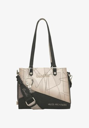 Sac à main beige et noir avec motifs abstraits en lignes, nom de la marque argenté "Anekke", bandoulière amovible et accessoire porte-bonheur, texte "La connaissance me rend puissant."