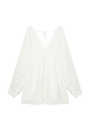 Weiße Bluse mit langen Ärmeln, tiefem V-Ausschnitt, lockerem Schnitt, elastischen Bündchen, Spitzenbesatz und dünner Bindung am Rückenausschnitt.