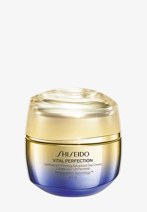 Shiseido Vital Perfection dagcreme-glas med gyldent og blåt gradientdesign, mærket opløftende og opstrammende, med ReNeuraRED Technology SPF 30.