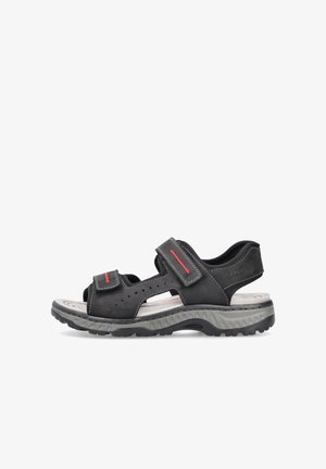 Sandales en cuir noir avec des sangles Velcro ajustables, design perforé, semelle en caoutchouc grise et touches rouges le long des sangles.