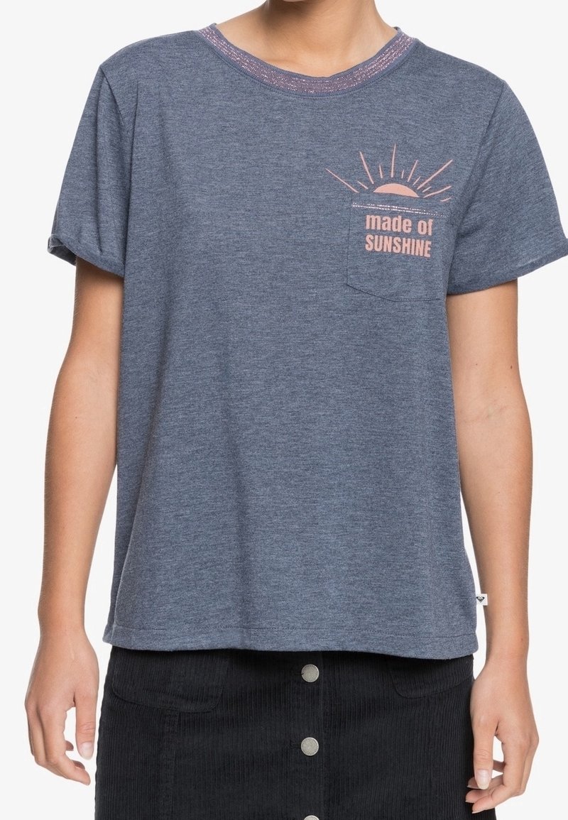 T-shirt à manches courtes, bleu marine, en tissu doux, avec un motif de poche rose portant le texte "fait de SOLEIL." Fini avec un col à motifs.