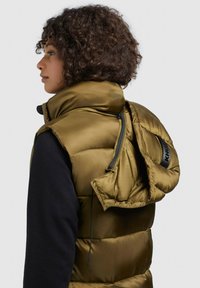 Olive green puffer vest featuring a detachable hood, zippered back, and black accents, crafted from smooth, glossy material.