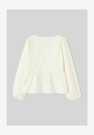 Haut péplum blanc avec manches longues bouffantes, tissu texturé présentant de petits points en relief, et encolure ronde dans le dos.