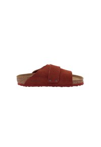 Red leather slide sandal featuring a textured upper, cork midsole, and a pronounced sole with contrasting accents. Adjustable strap detail included.