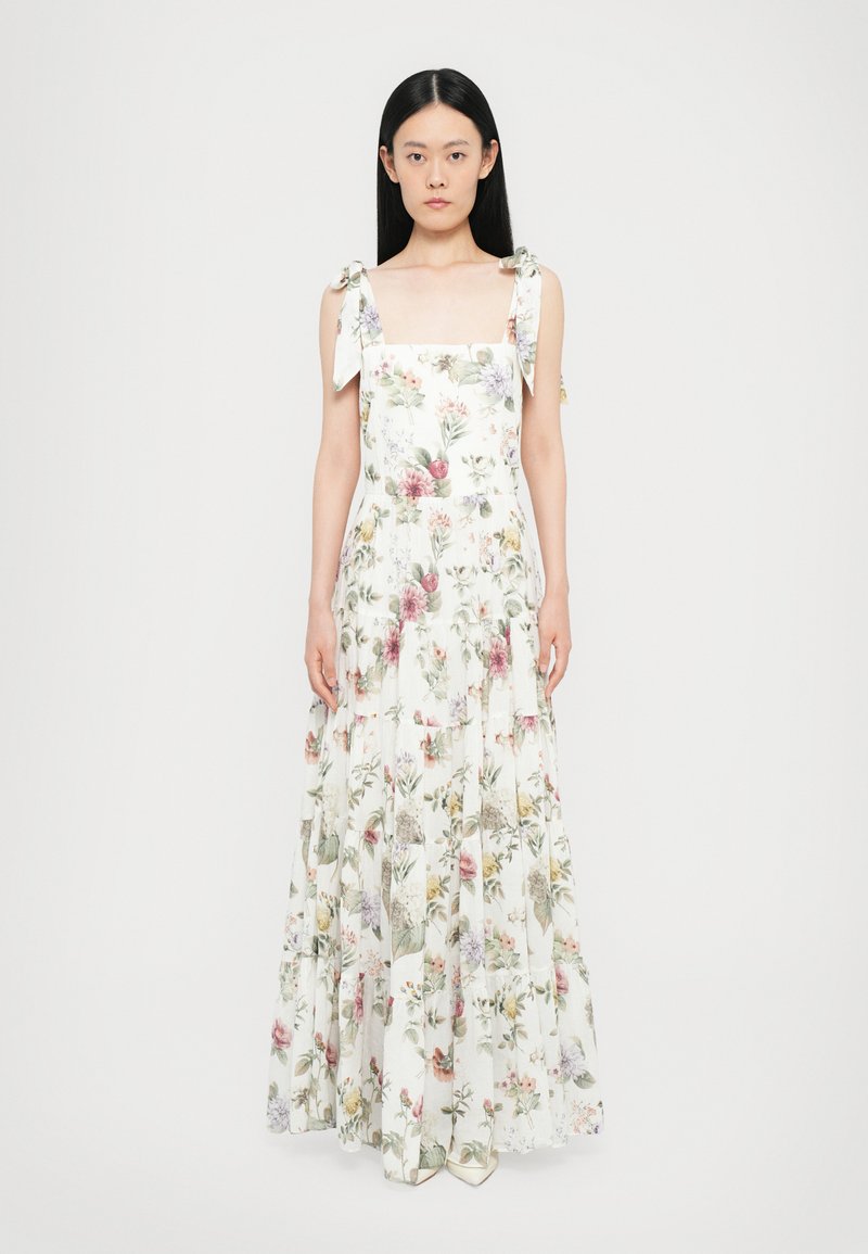 Floral maxi dress with square neckline, adjustable tie straps, and layers. Features pastel flower patterns on a white background.