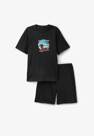 Czarny zestaw z krótkim rękawem T-shirt i szortami z grafiką jamnika jeżdżącego na deskorolce na plaży, z podpisem "Enjoy the Ride."