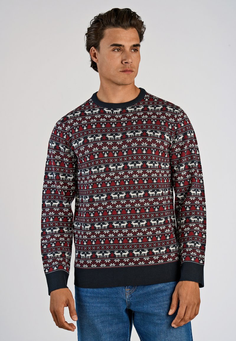 Röd och marinblå mönstrad tröja med vita renmotiv och blommönster. Stickad tyg med ribbade ärmslut och midja. Avslappnad passform.