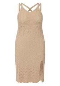 Stickad klänning i beige med en åtsittande design, korsade axelband, en texturerad mönster och en fåll med en sidoplyv.
