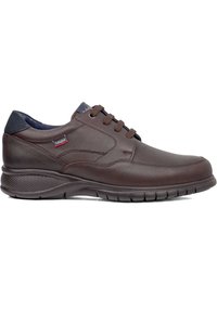 Scarpe in pelle marrone con punta rotonda, design con lacci e collo imbottito. Presentano una suola in gomma testurizzata per aderenza e comfort.