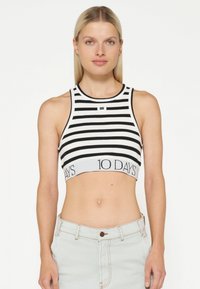 Zwart-wit gestreepte crop top met een ronde halslijn en een elastische band met de tekst "10 DAGEN." Gemaakt van rekbare stof.