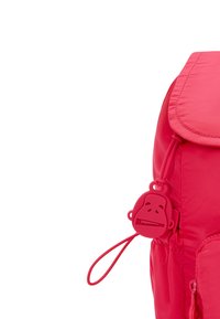 Zaino rosa brillante con una texture liscia, patta arrotondata e un tirazip a forma di faccia di scimmia. Presenta una chiusura regolabile con cordoncino.