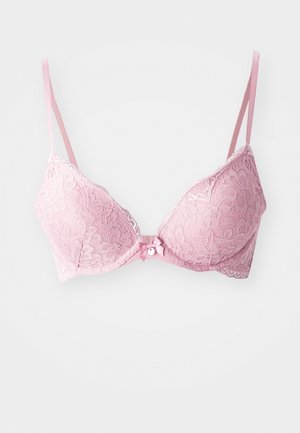 Pink lace bra with a floral pattern, padded cups, adjustable straps, and a small bow detail at the center front. Textured finish.