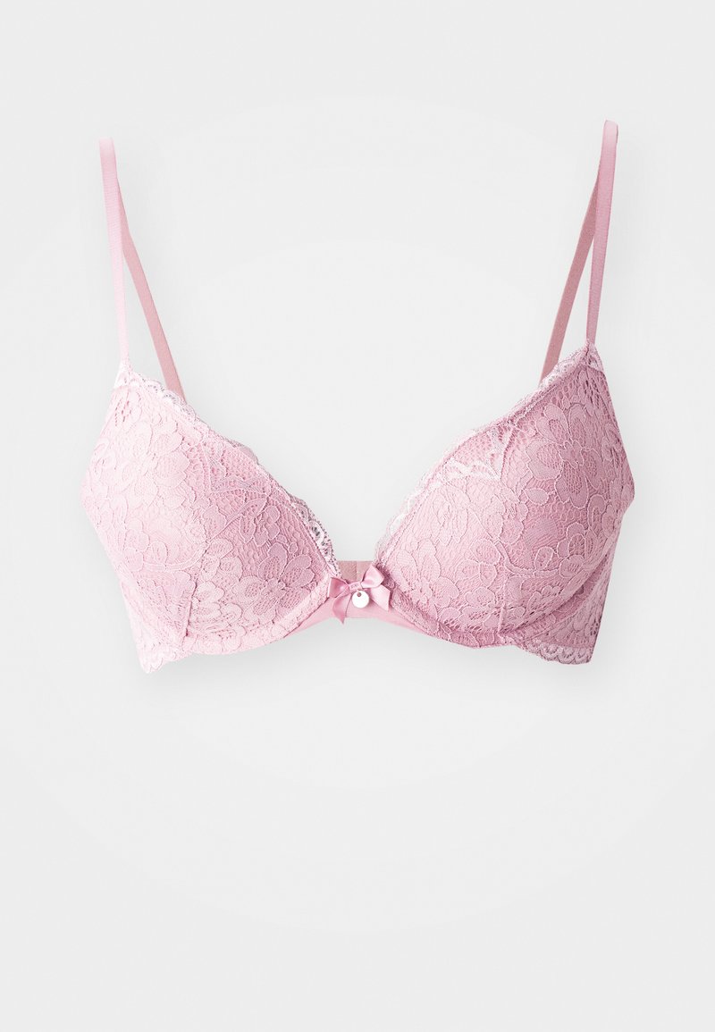 Roze kanten beha met een bloemenpatroon, gevoerde cups, verstelbare banden en een klein strikdetail aan de voorkant. Getextureerde afwerking.