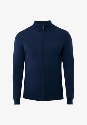 Maglione zip-up blu navy con collo alto, realizzato in materiale knit. Presenta polsini e orlo a coste, design semplice e piccolo logo sul petto.