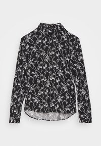 Chemise noire à manches longues boutonnée avec motif de vigne florale blanche et col pointu, posée à plat sur fond blanc.
