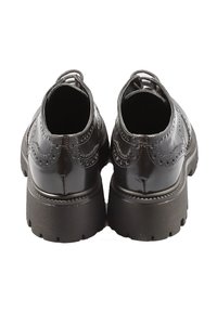 Scarpe in pelle verniciata nera con dettagli brogue, punta rotonda e suola spessa e texture. Caratterizzano un tacco basso e accenti cuciti.