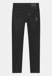 Black denim jeans with a straight cut, two back pockets, and subtle distressed detailing. Features a Levi's brand patch at the waist.