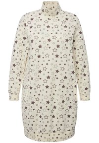 Tunic a maniche lunghe color crema, con un motivo a stelle marroni. Tessuto morbido, colletto alto e polsini a costine, dal taglio rilassato.