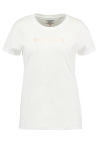 Bílá dámská tričko s krátkým rukávem a kulatým výstřihem, se světle růžovým nápisem „tommy jeans“ umístěným na hrudi.