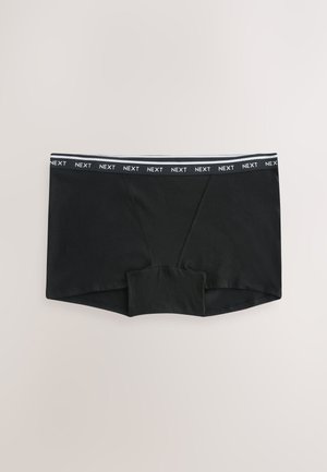 Boxer neri con una cintura elastica brandizzata che ripete la parola "NEXT", distesi su uno sfondo chiaro.