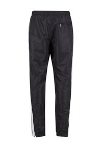 Černé sportovní kalhoty s bílými bočními pruhy, elastickým pasem, kapsou na zip na zadní straně a elastickými manžetami na kotnících.