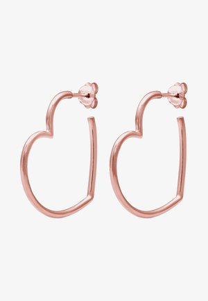 Boucles d'oreilles en métal or rose en forme de cœurs ouverts avec fermoirs papillon, présentées sur fond blanc.