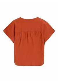 Blouse à manches courtes couleur orange rouille avec un détail froncé sur le haut du dos et une coupe ample et carrée.