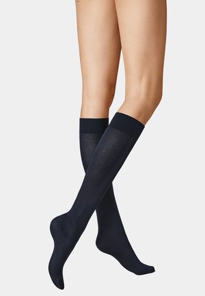 Marineblaue knielange Socken aus einem glatten Material in einfarbiger Ausführung, mit einem gerippten Bündchen und einer körpernahen Passform.
