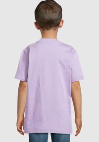 Lilac short-sleeve t-shirt with a crew neckline, soft cotton texture, and straight hem, worn by a child. Back view shows simple design.