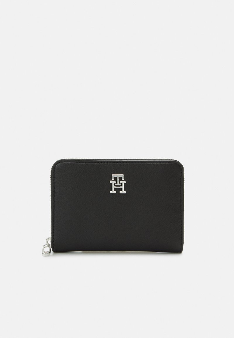 Black leather wallet with a textured finish, featuring a silver logo on the front. It has a zip closure and a compact rectangular shape.