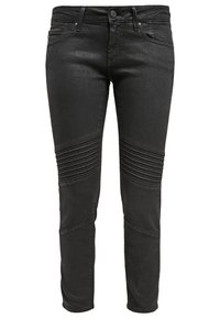 Svarta smala jeans i denim med texturerade horisontella sömmar på knäna och en framficka med dragkedja.