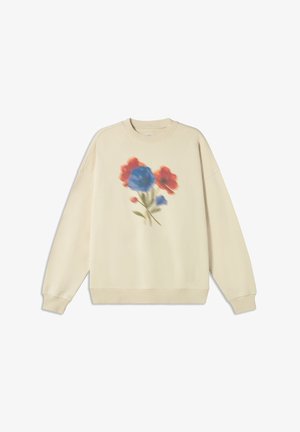 Kremowa bluza z kwiatowym wzorem w niebieskich i czerwonych odcieniach, z ściągaczami przy mankietach i u dołu, o luźnym kroju. Gładka faktura.