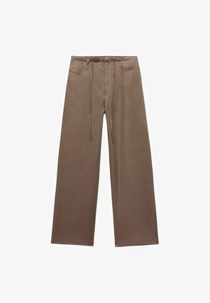 Bruna vida byxor i linne med resårband i midjan och två fickor. Slät textur och minimalistisk design.