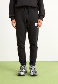The North Face - Tracksuit bottoms - black Thumbnail Image 1